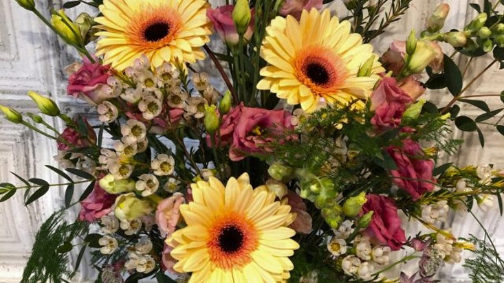 A display of summer flowers in a vintage jug